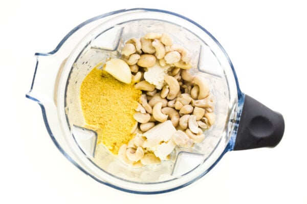 Looking down on a blender with tofu, cashews, and other ingredients..