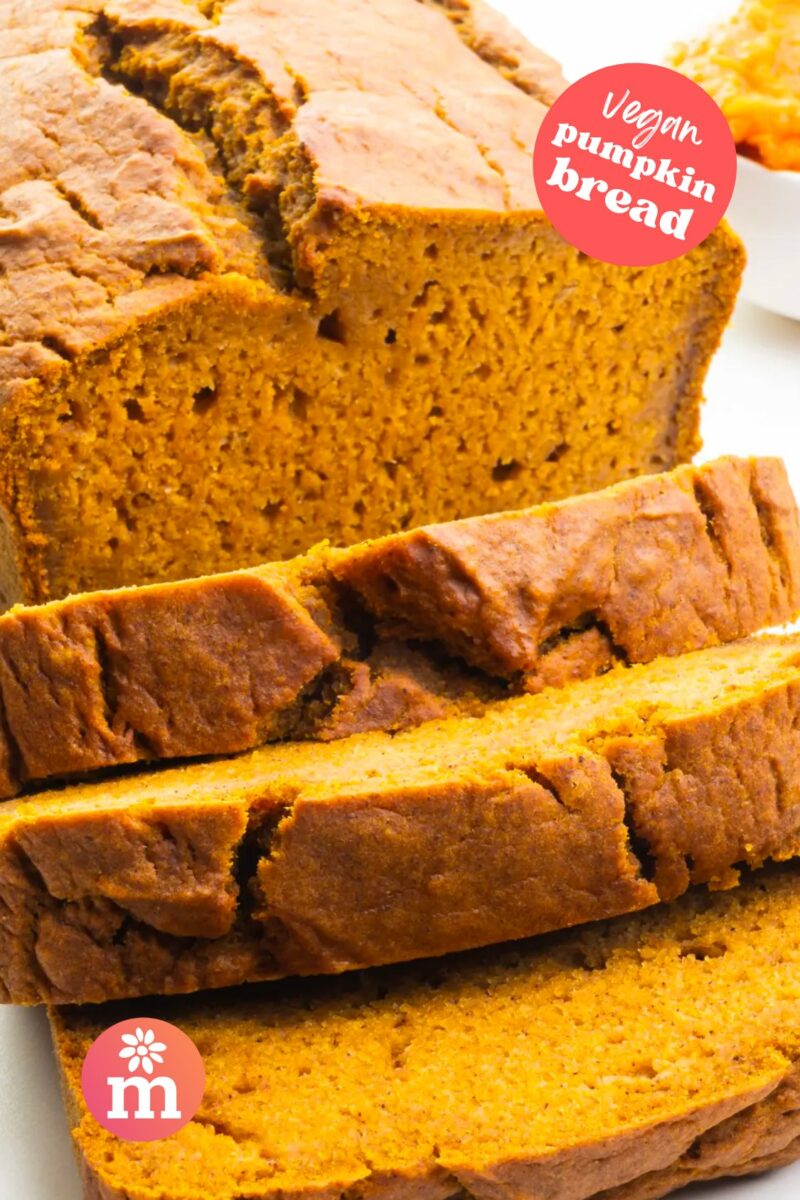 A pumpkin loaf has several slices cut out. The text reads, Vegan Pumpkin Bread.