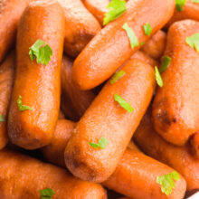 A close-up shot shows roasted balsamic carrots with fresh parsley on top.
