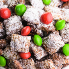 Looking down on a bow full of reindeer chow with red and green candies.