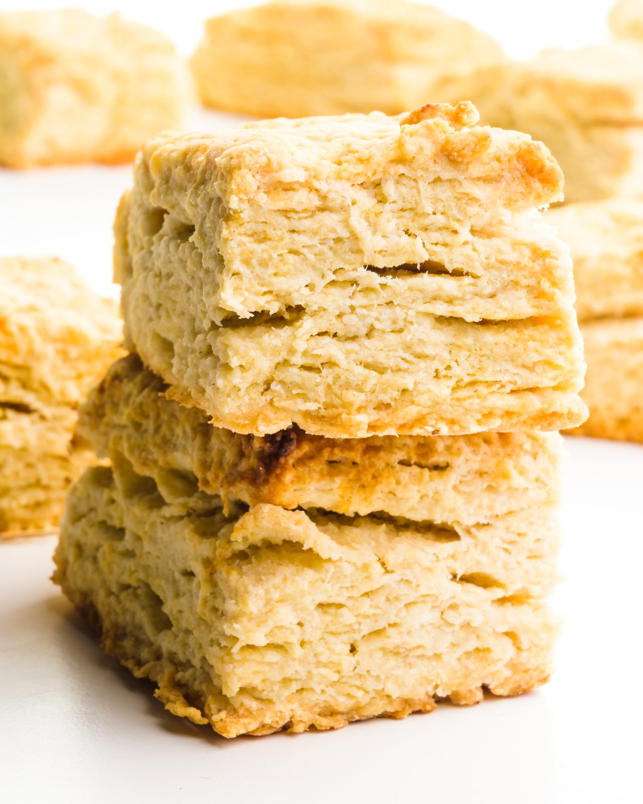 A stack of two rectangle biscuits sit in front of more biscuits.