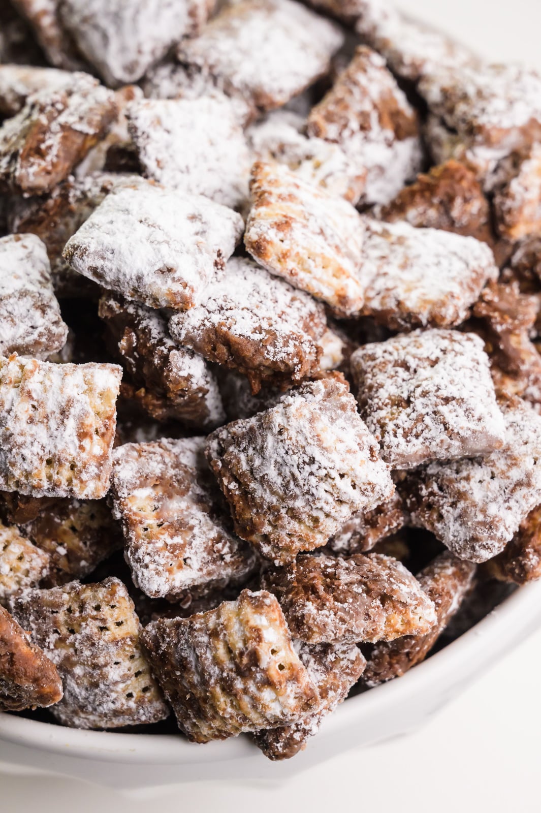 A close-up shot of vegan puppy chow, chocolate-covered cereal mixture, otherwise known as muddy buddies.