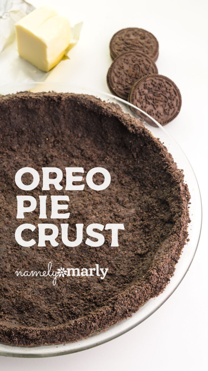 Oreo pie crust in a glass dish with butter and Oreo cookies in the background.