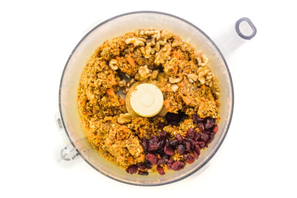 Looking down on a food processor bowl full of ingredients.
