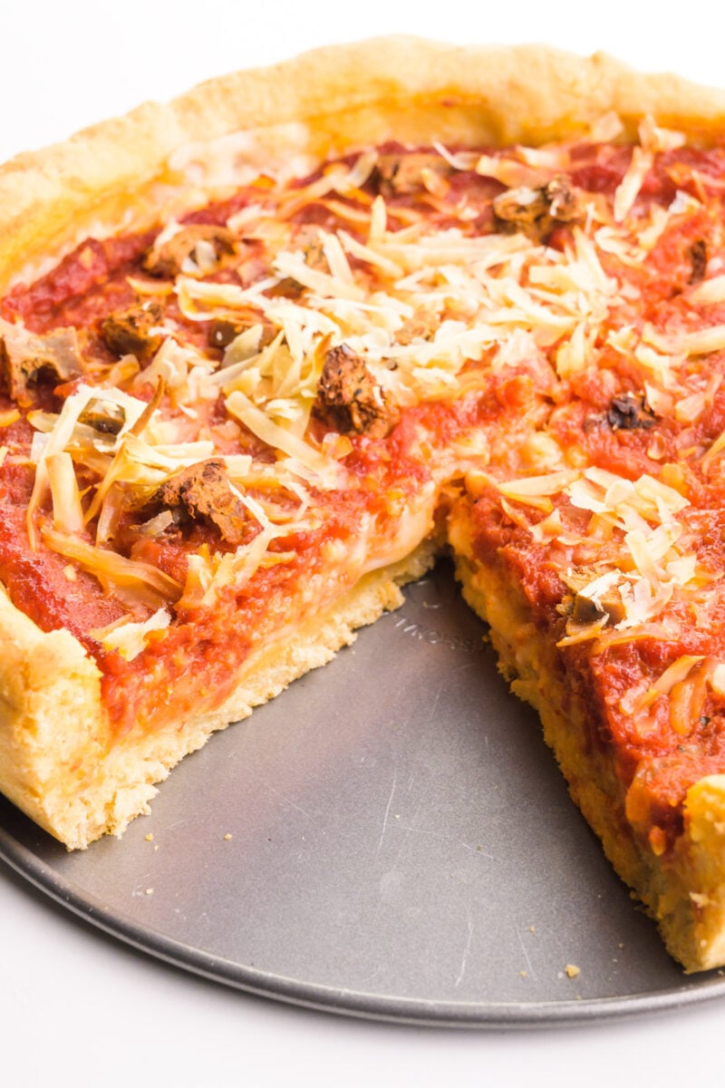 Looking into a slice taken out of a vegan deep dish pizza.