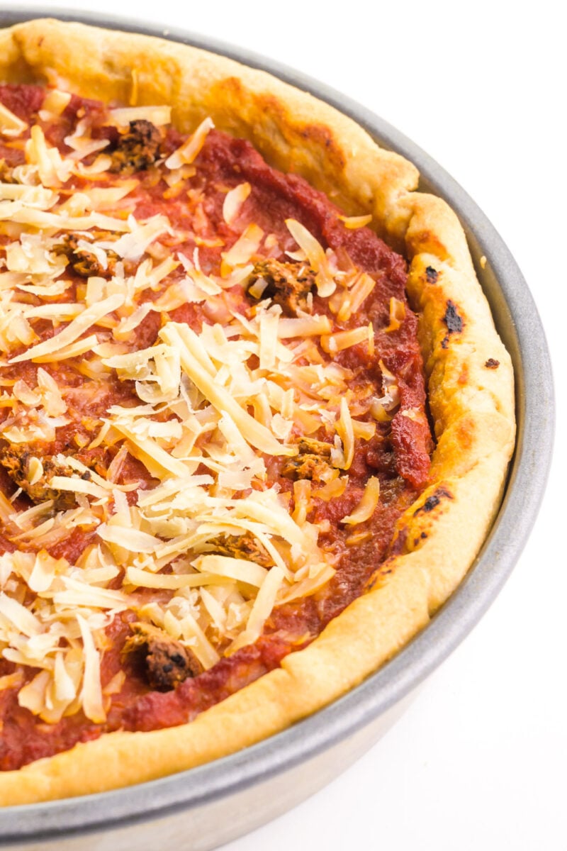 Looking down on a vegan deep dish pizza in the pan, right after it's pulled from the oven.