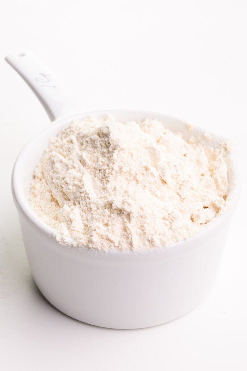 A measuring cup holds whole wheat pastry flour.
