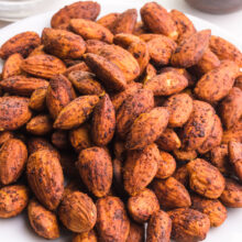 Looking down on a bowl of baked spiced almonds.