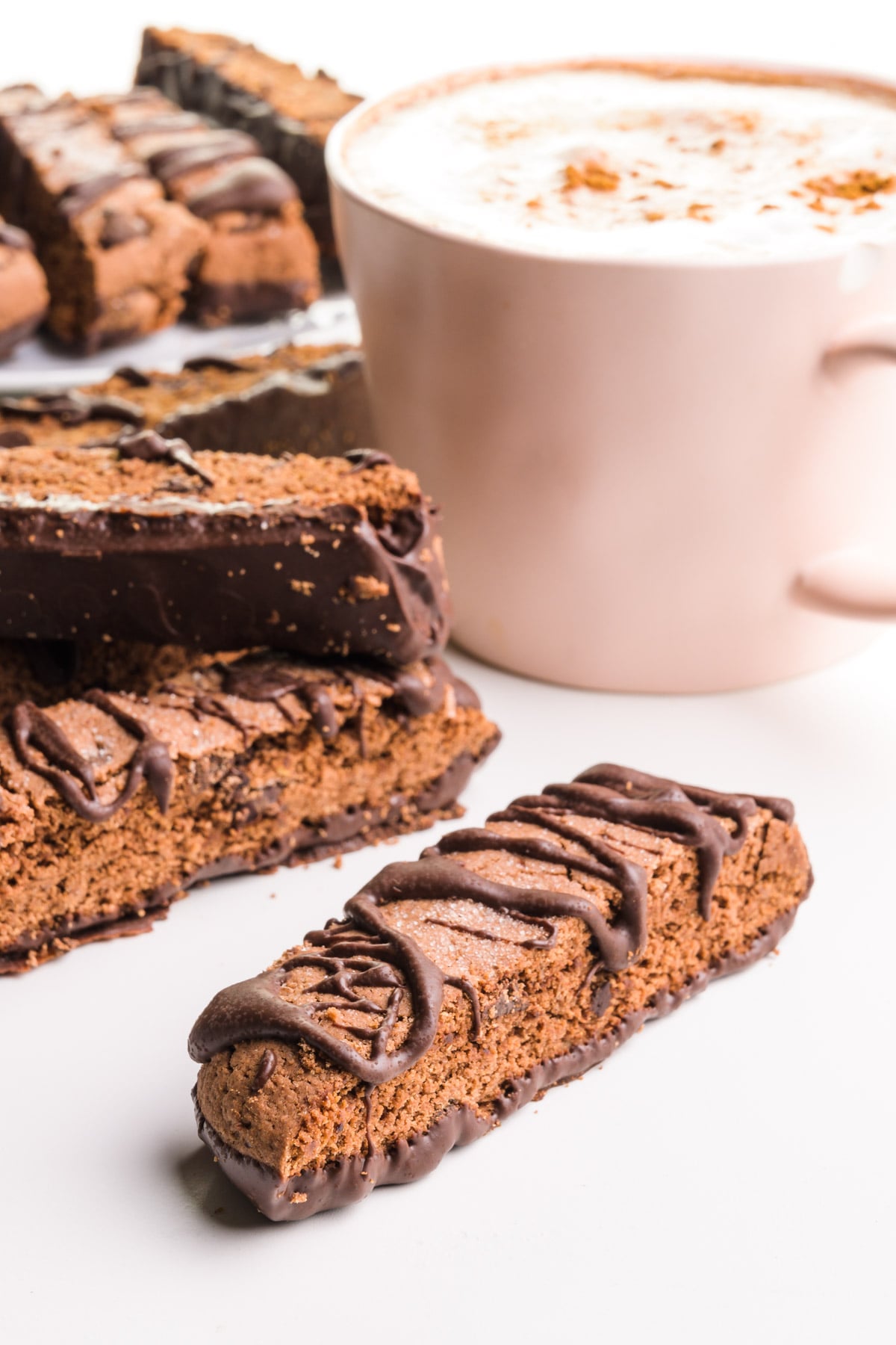 Crunchy cookies sit next to a mug full of hot tea.