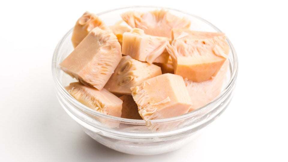 A glass bowl holds several pieces of canned jackfruit.