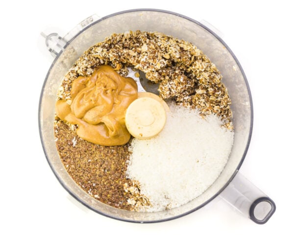 Ingredients such as peanut butter, flaxseed, coconut flakes, and ground up oatmeal with dates.