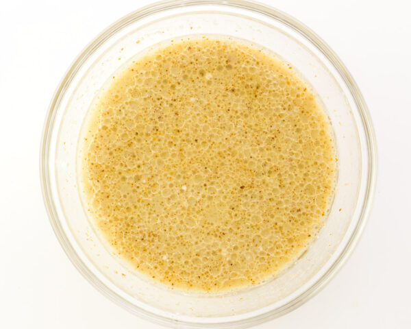 Looking down on a bowl with wet ingredients combined for muffin batter.
