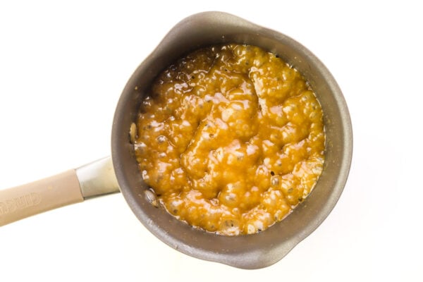 Looking down on a saucepan full of brown sugar and vegan butter that has come to a low boil.