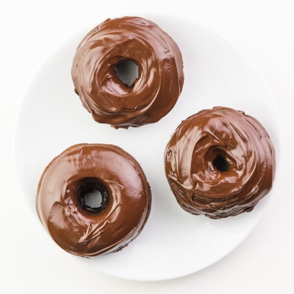 Looking down on donuts recently dipped in chocolate glaze.