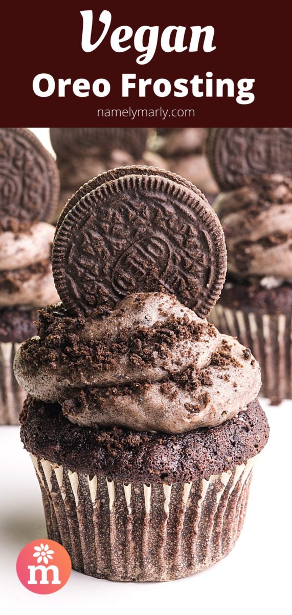 A chocolate cupcake has a generous portion of frosting and an Oreo cookie on top. There are more cupcakes like it in the background. The banner text at the top reads, Vegan Oreo Frosting.