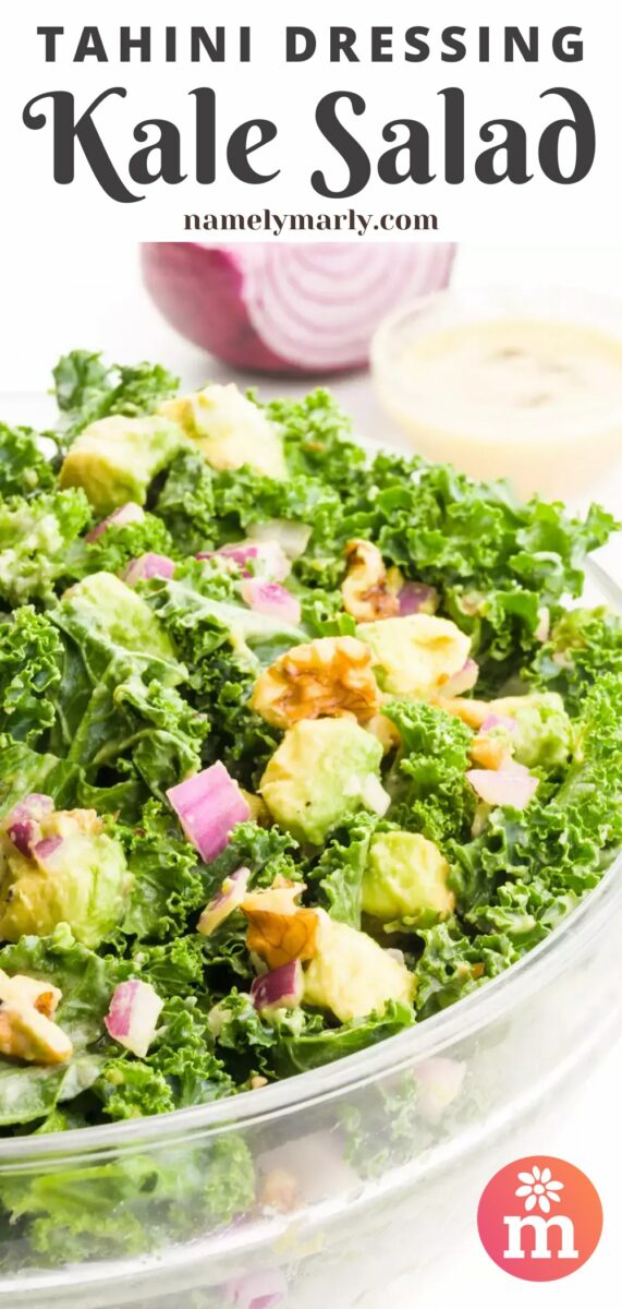 A large bowl holds kale salad, showing curly green kale, chopped walnuts, red onions, and bits of green avocados. There's more of the dressing and a red onion in the background. The text at the top of the image reads, Tahini Dressing Kale Salad.