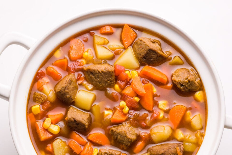 Looking down on a pot full of vegan beef stew.