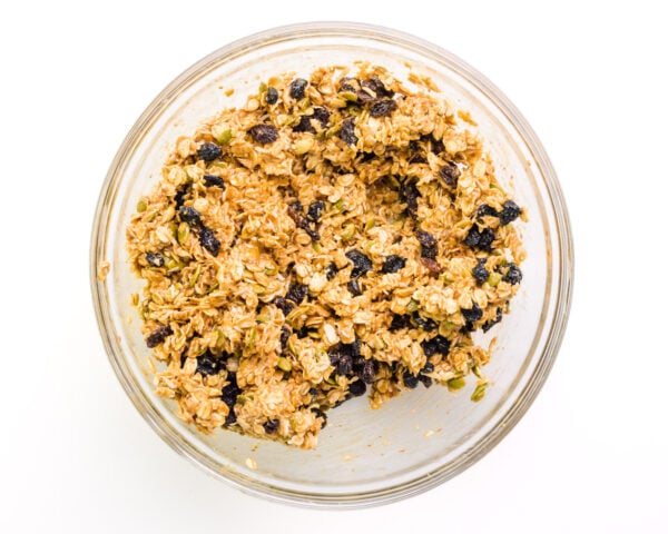 Looking down on a bowl of cookie dough with dried blueberries.