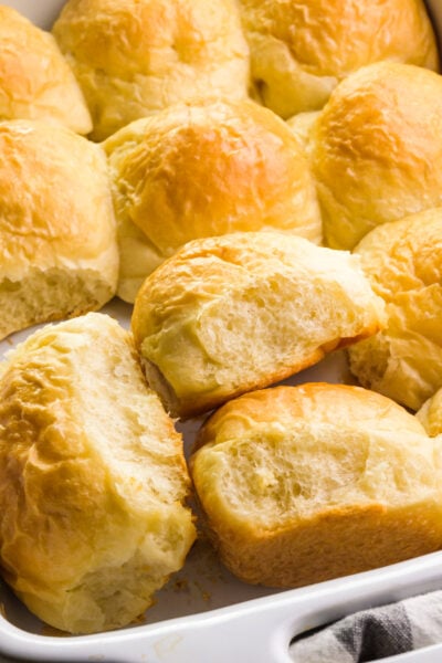 Looking down on dinner rolls in a baking dish, with some of them turned sideways.