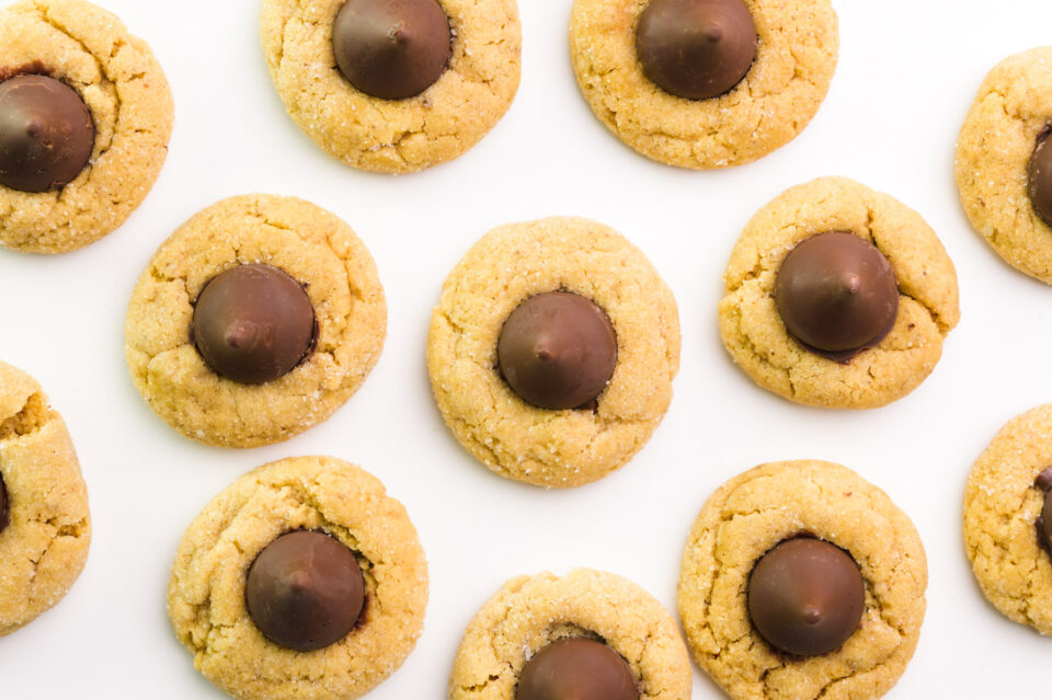 Looking down on peanut butter blossoms vegan cookies on a white counter.