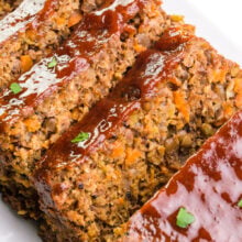 Looking down on slices of vegan meatloaf on a platter.