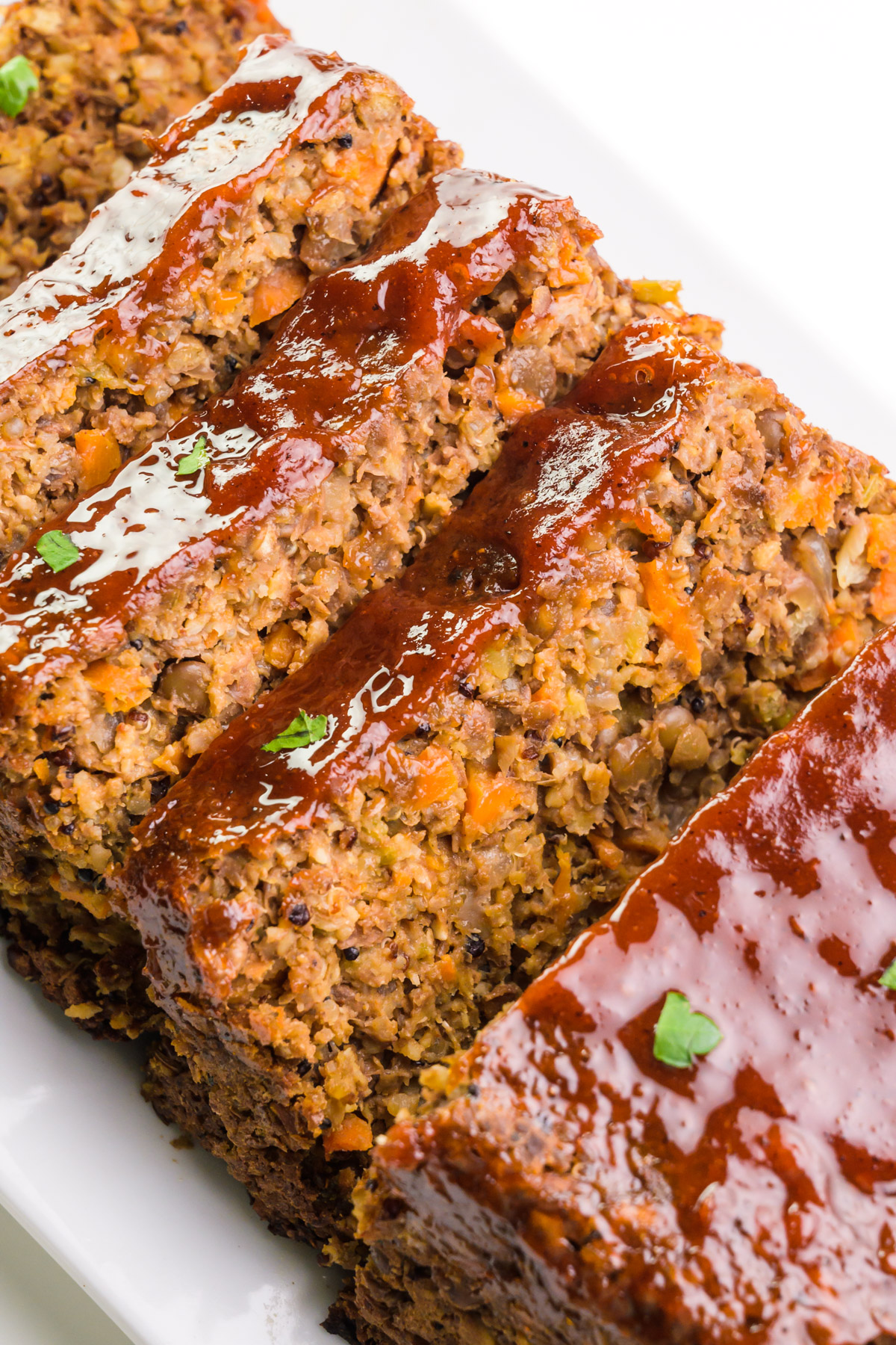 Looking down on slices of vegan meatloaf on a platter.