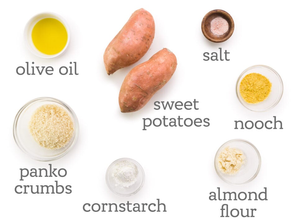 Ingredients are laid out on a table, including sweet potatoes, salt, notch, almond flour, cornstarch, panic crumbs, and olive oil.
