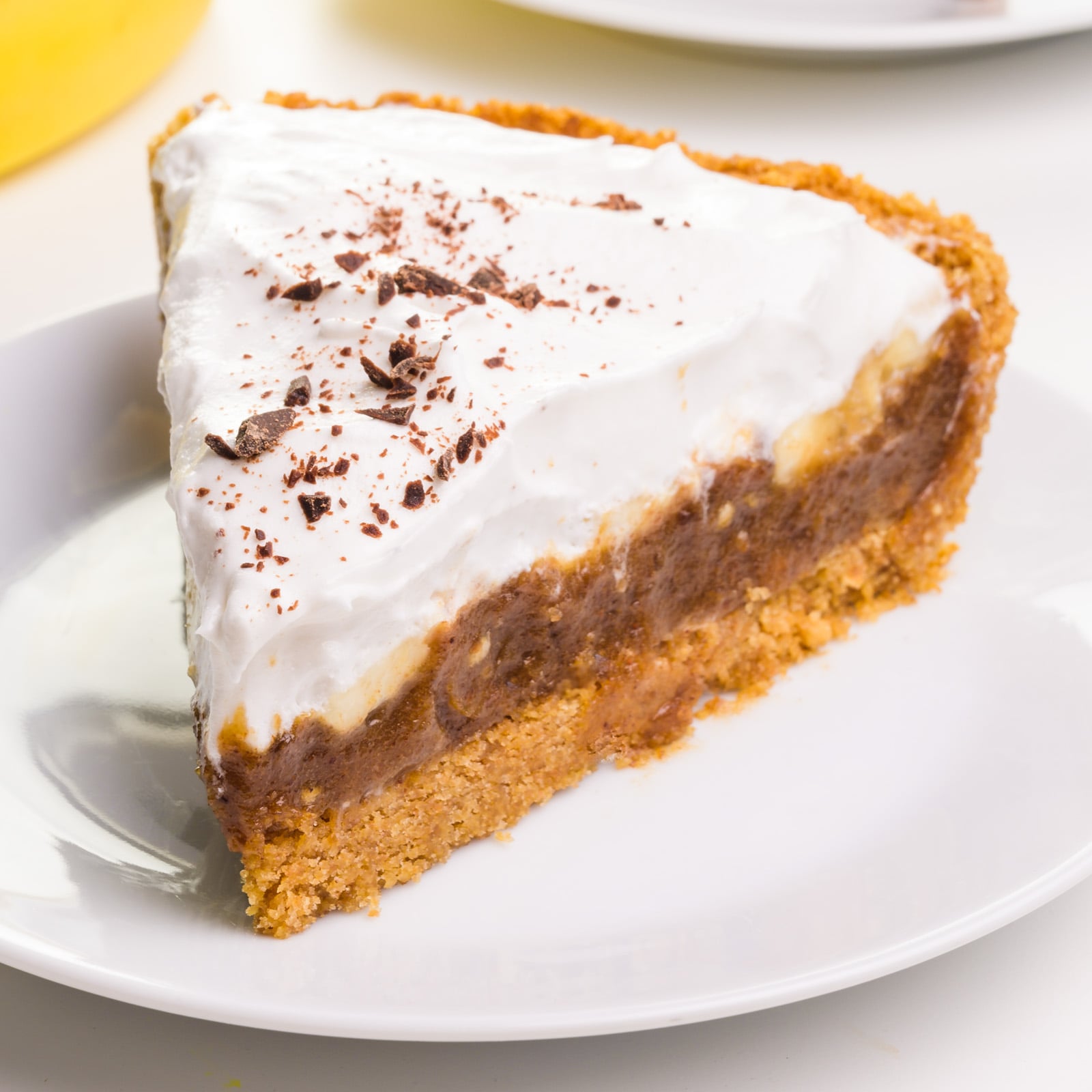 A slice of vegan banoffee pie sits on a plate.