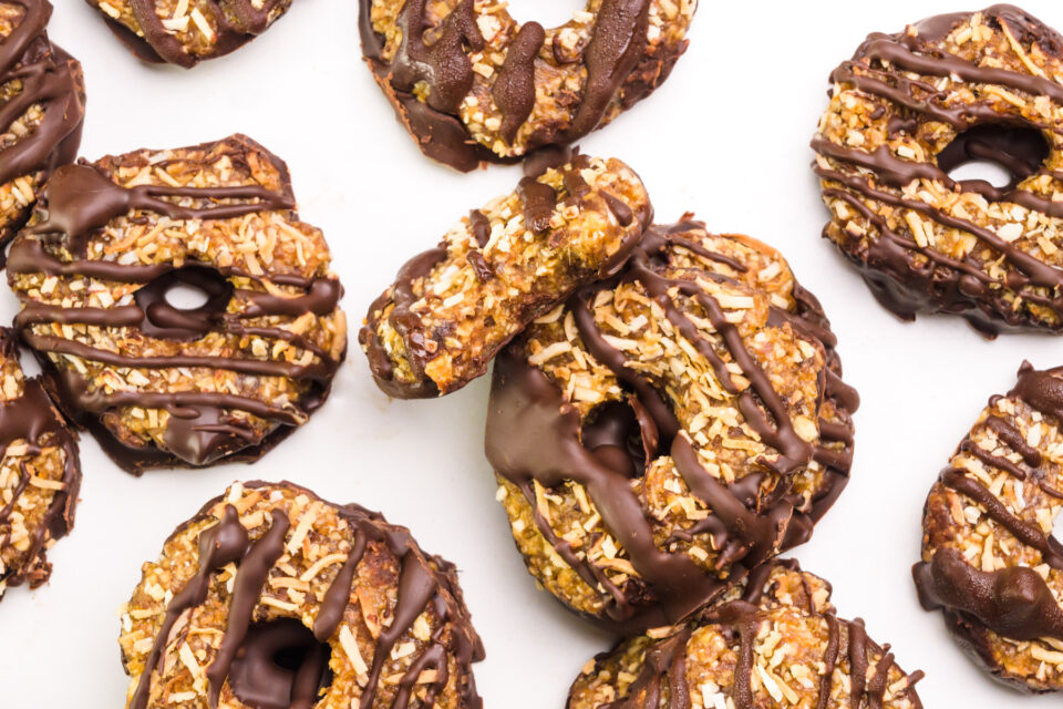 Looking down on vegan Samoas cookies, one with a bite taken out of it.