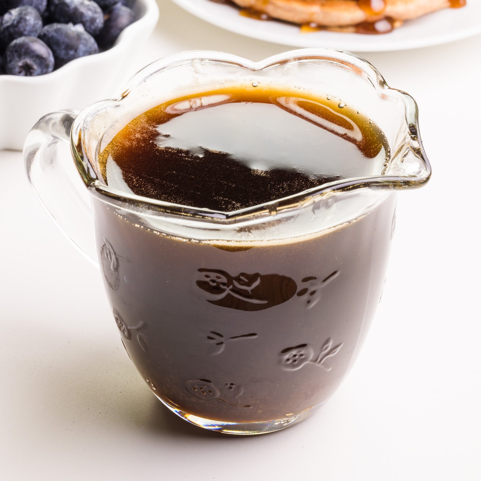 Mock maple syrup is in a glass syrup pitcher.
