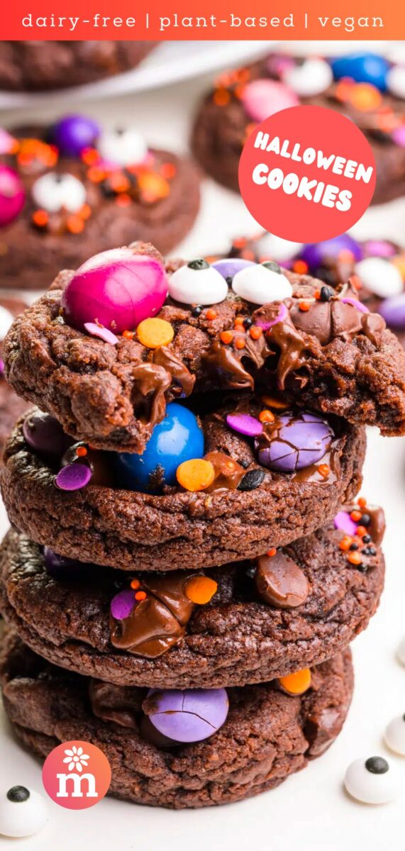 A stack of chocolate cookies shows the top one with a bite taken out. The text reads, dairy-free-plant-based, vegan Halloween cookies.