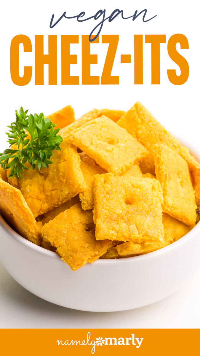 Vegan Cheez-Its in a white bowl, garnished with a small sprig of parsley.