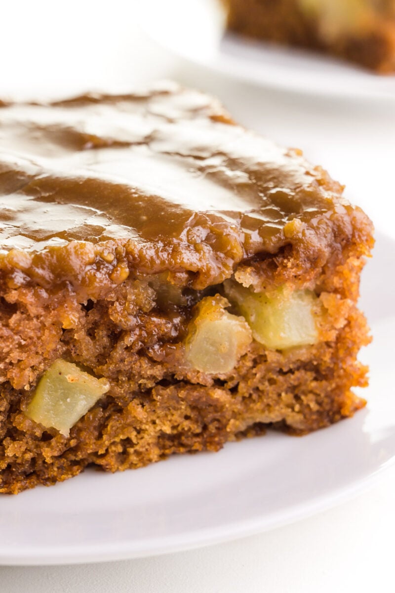 A close-up of egg free apple cake, showing bits of apple in the cake.