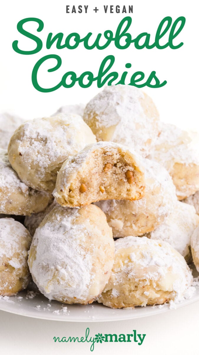A closeup of a plate of snowball cookies. One has a bite taken out. Text reads Easy Vegan Snowball Cookies.