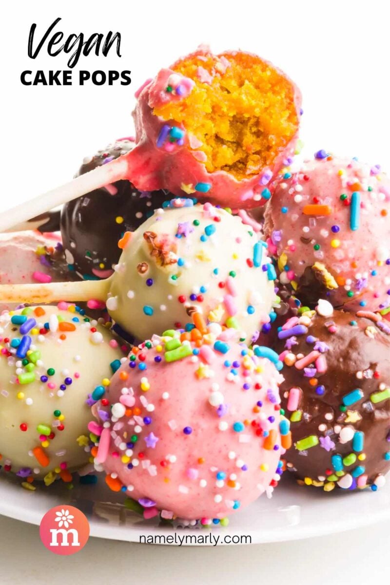 A stack of cake pops shows the top one with a bite taken out. The text reads, Vegan Cake Pops.