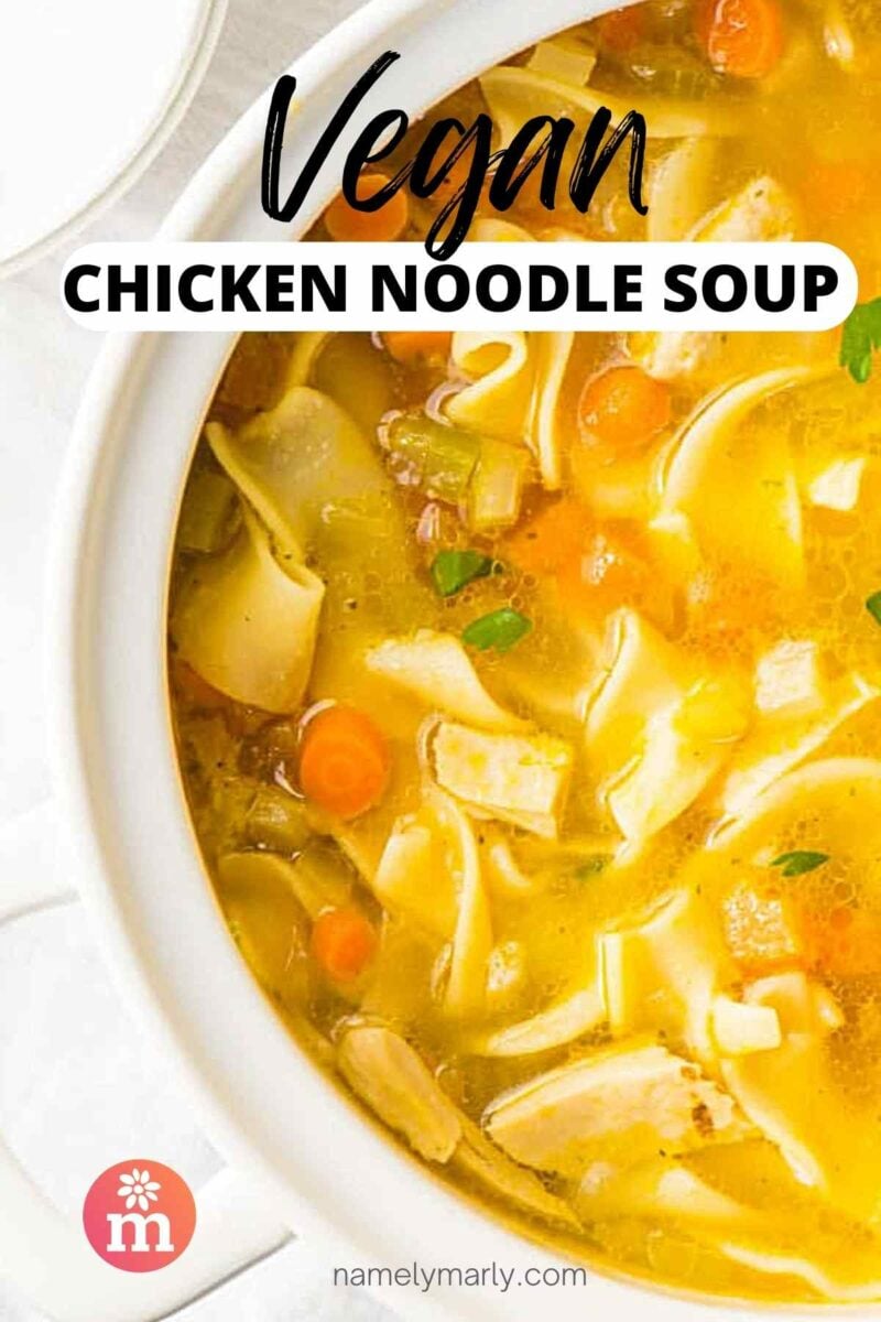 Looking down on soup in a white pot. The text reads, Vegan Chicken Noodle Soup.