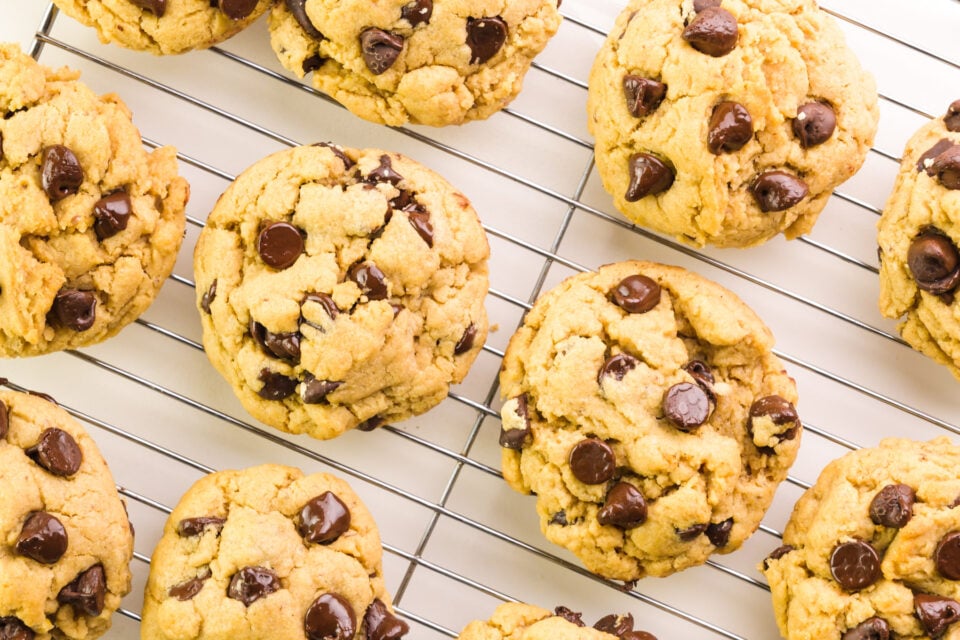 Looking down on chocolate chip cookies cooling on a wire rack.