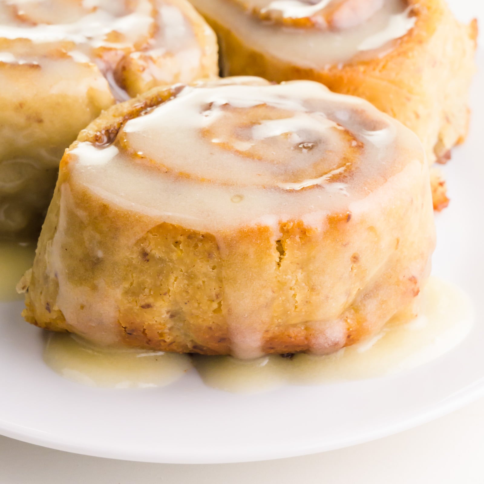 A closeup of vegan gluten-free cinnamon rolls on a plate.