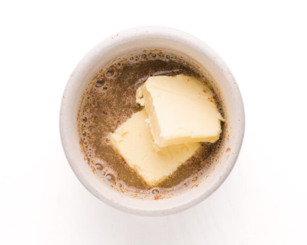Vegan butter is combined with a flax egg in a bowl.