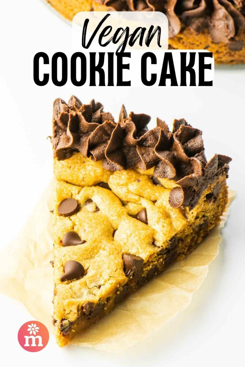 A slice of cookie cake has chocolate frosting at the edge. The text reads, Vegan Cookie Cake.