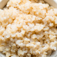 Looking down on a bowl of cooked brown rice.