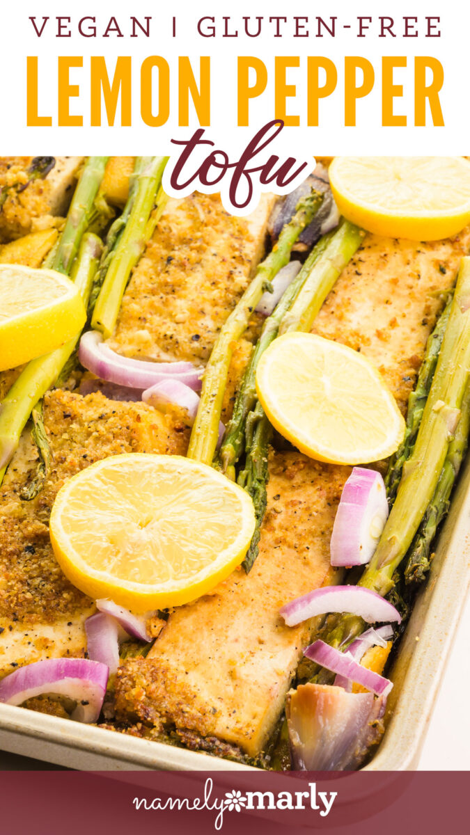 Vegan lemon pepper tofu with asparagus and lemon slices in a baking dish.