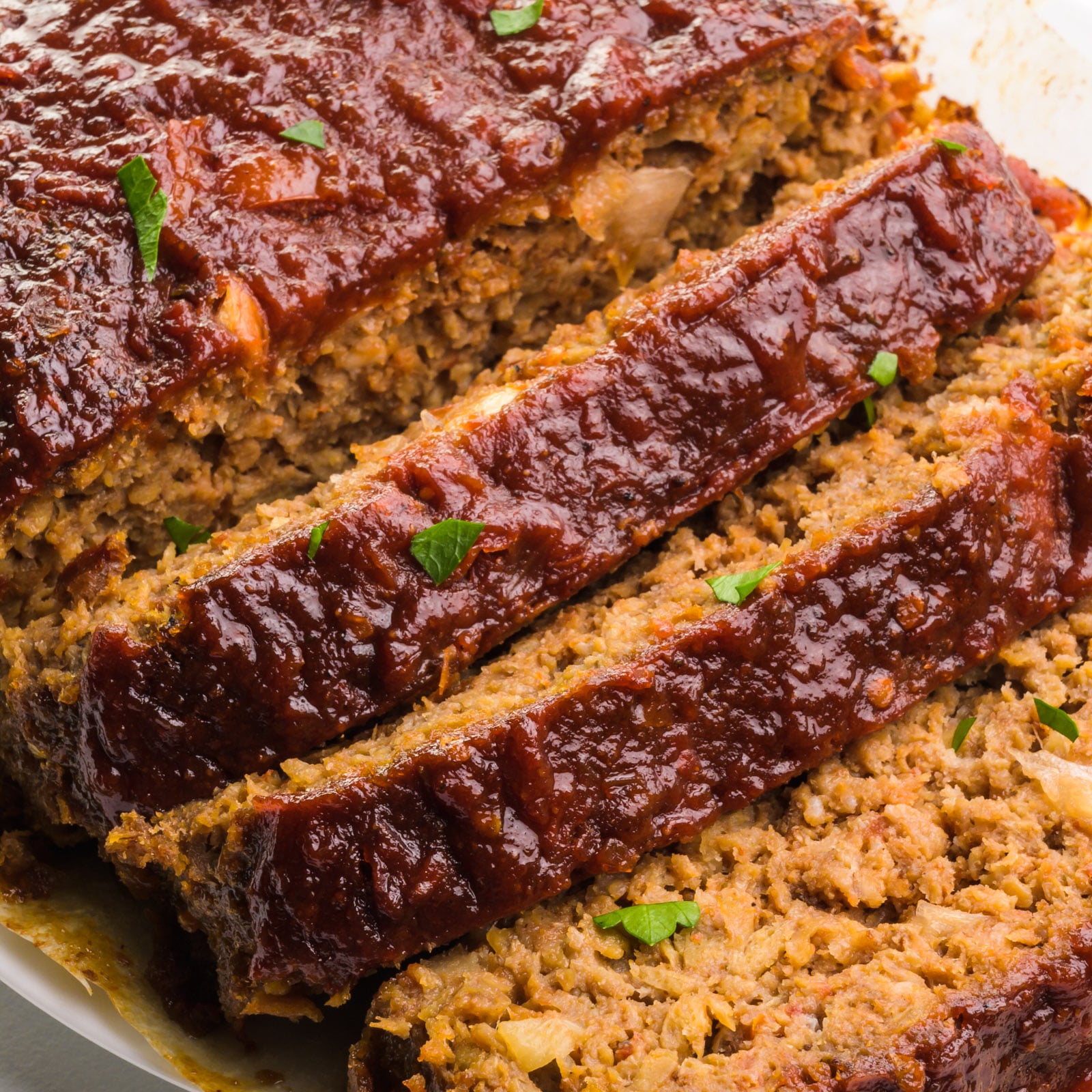 Looking down on an Impossible meatloaf with a few slices showing the interior of the meatloaf.