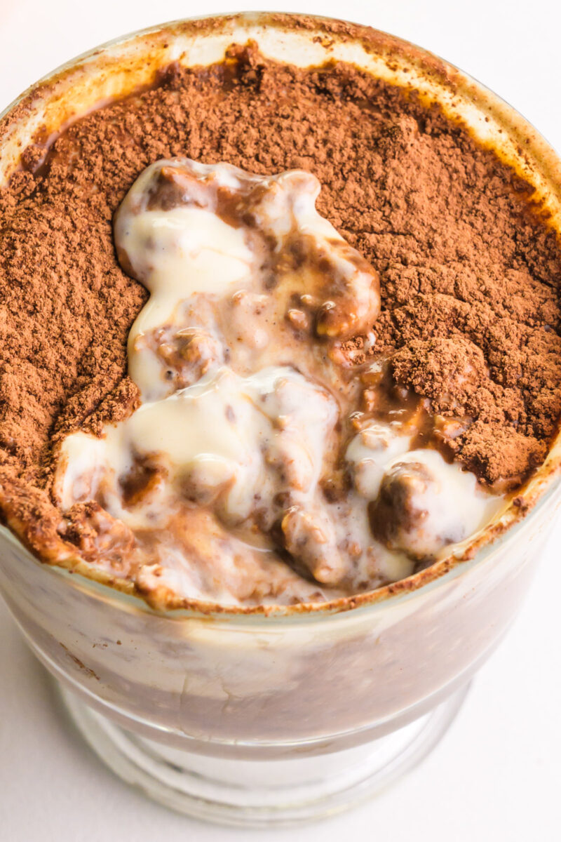 Looking down on a bowl of tiramisu overnight oats with a bite taken out.