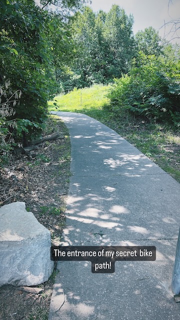 A bike path has trees on both sides. The text reads, My secret bike path."