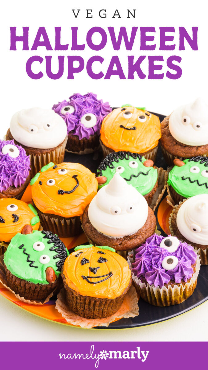 Colorful vegan Halloween cupcakes decorated with various spooky faces and designs on a plate.