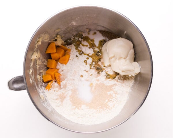 Ingredients are in a mixing bowl, including flour, sweet potatoes, and more.