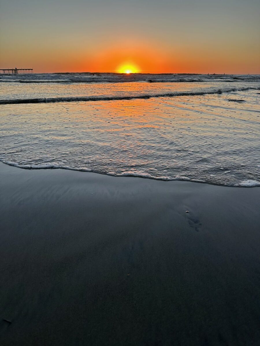 A photo of a setting sun over the Pacific Ocean.
