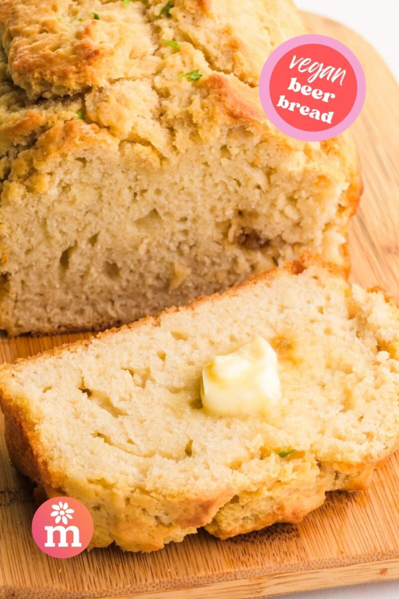 A loaf of bread has a slice cut out with a pat of butter on it. The text reads, Vegan Beer Bread.