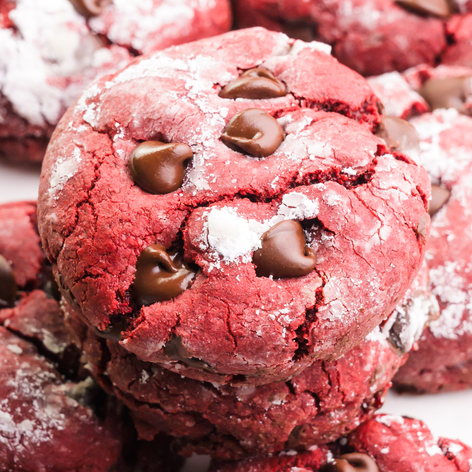 Looking down on vegan Red Velvet Cookies stacked with more cookies all around them.